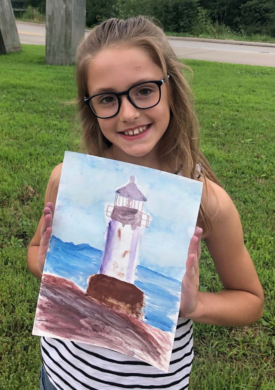 Image of child holding a painting of a lighthouse